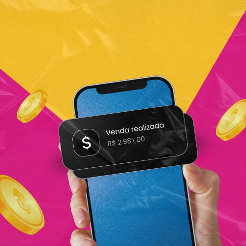 Mão segurando um smartphone com uma notificação de "Venda realizada – R$ 2.987,00" na tela, sobre fundo amarelo e rosa com moedas ilustradas ao redor.
